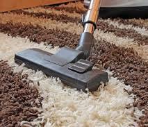 cleaning a carpet with the use of vacuum cleaner